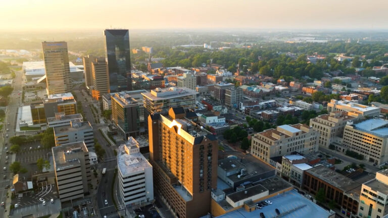 Overhead view of city downtown area with tal buildings.