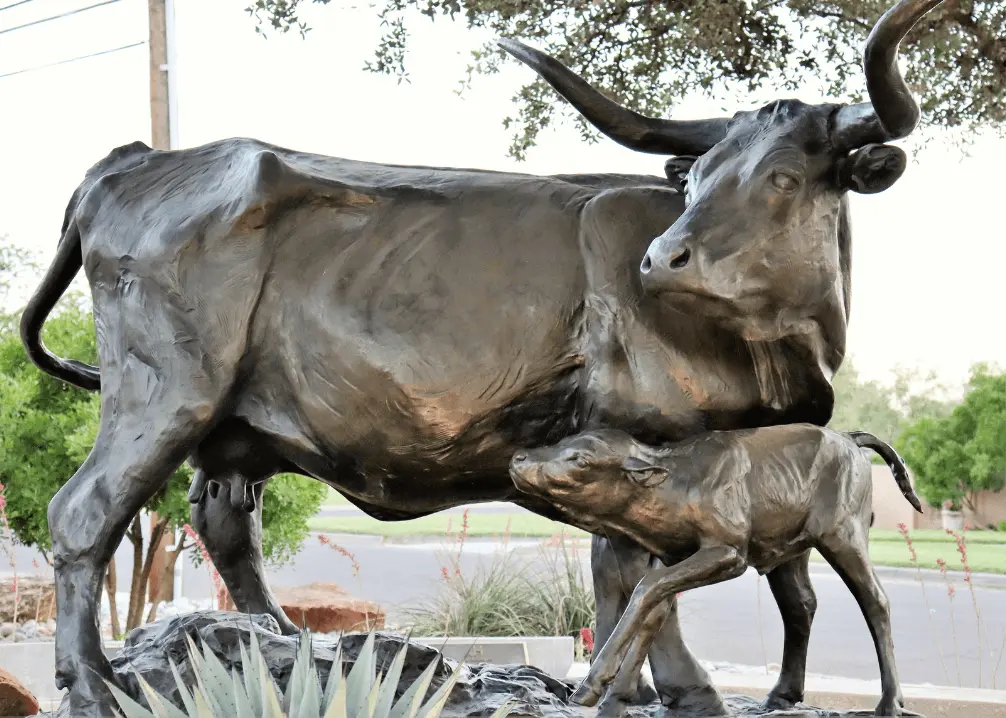 Bronze statue of longhorn cow with calf