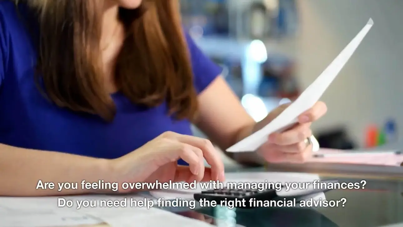 Woman holding sheet of paper and running a 10 key calculator